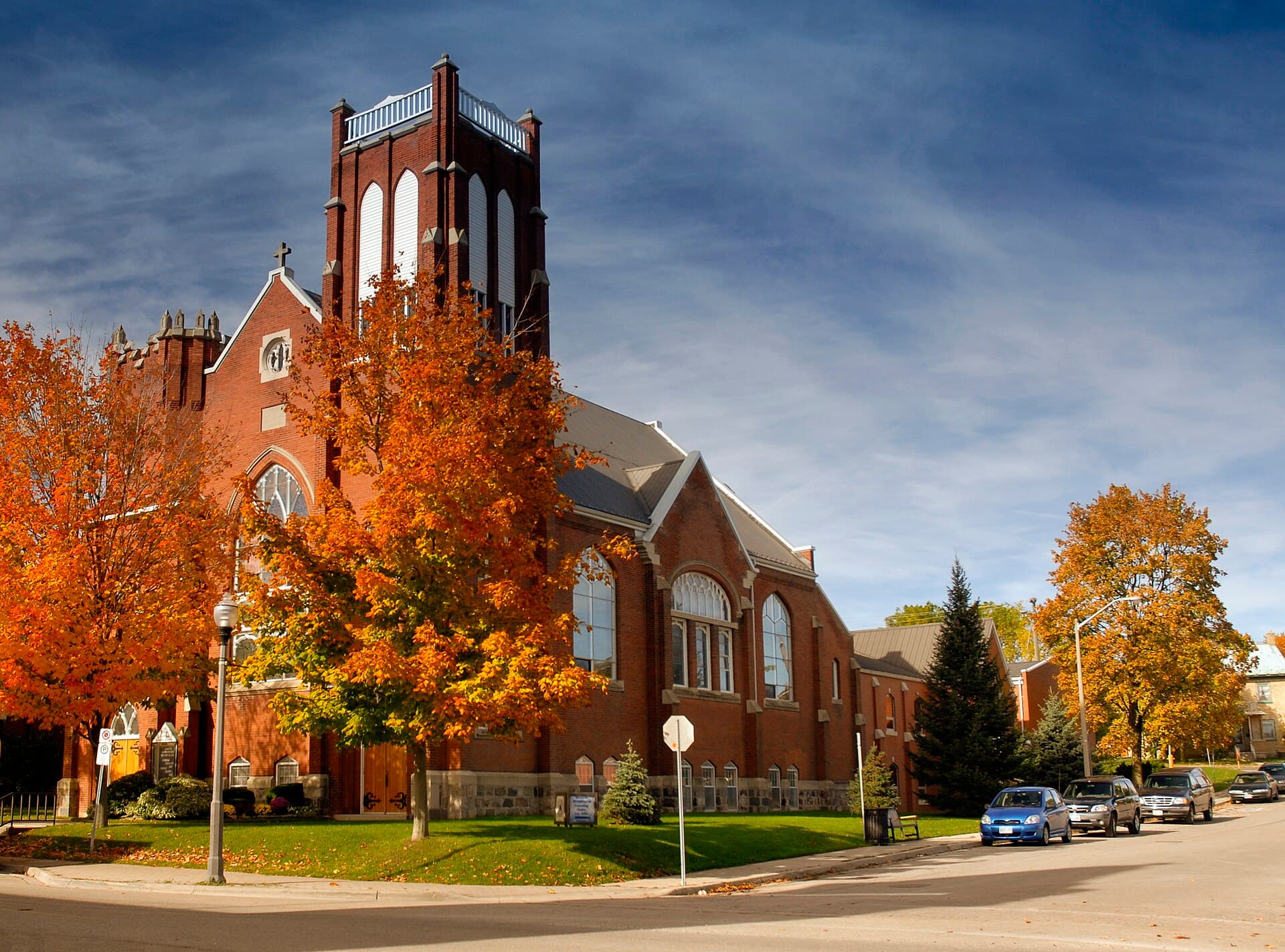St. James Lutheran Church in Elmira, its brick tower behind autumn maples
